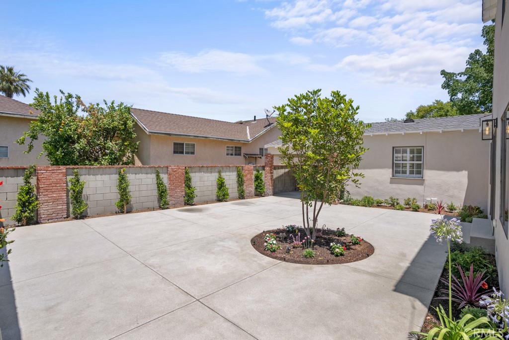 731 North Beachwood Drive Burbank, CA 91506 - Photo 6 of 53 a front view of a house with yard and trees in the background