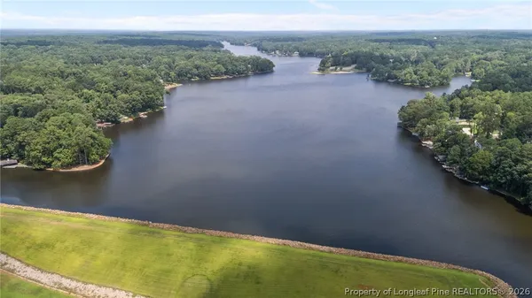 an aerial view of a house with a lake view