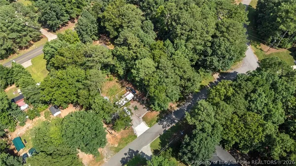 an aerial view of a houses with yard