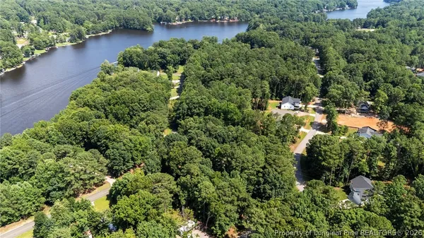 an aerial view of a house with yard and outdoor seating