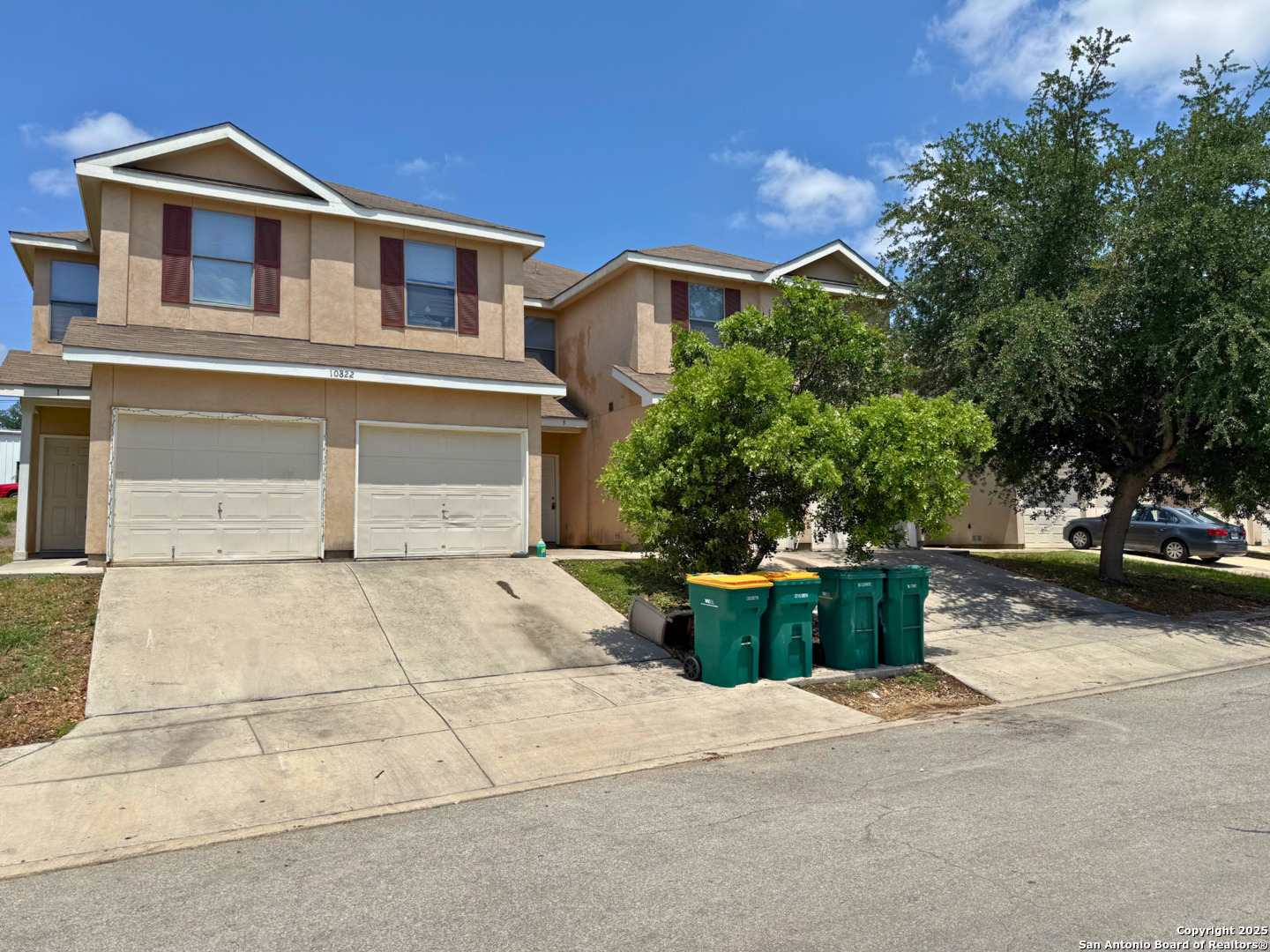 10822 Mathom Landing, Unit 3 Universal City, TX 78148 - Photo 1 of 14 a front view of a house with a yard and trees
