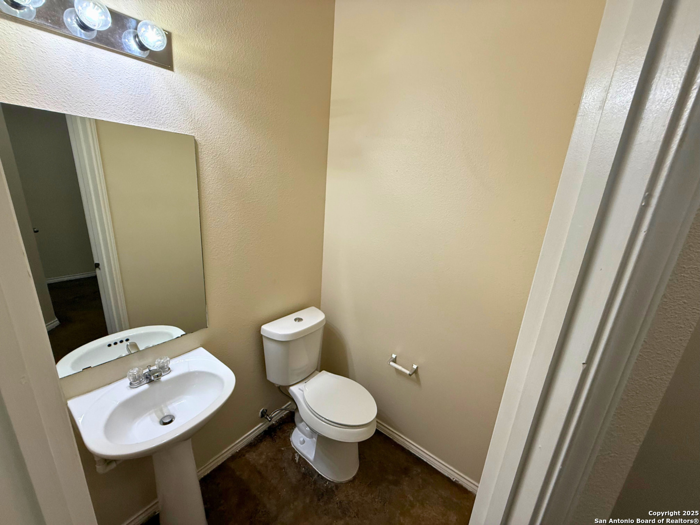 10822 Mathom Landing, Unit 3 Universal City, TX 78148 - Photo 14 of 14 a bathroom with a toilet a sink and a mirror