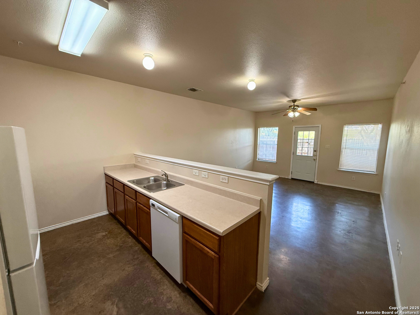 10822 Mathom Landing, Unit 3 Universal City, TX 78148 - Photo 2 of 14 a kitchen with a stove and a refrigerator