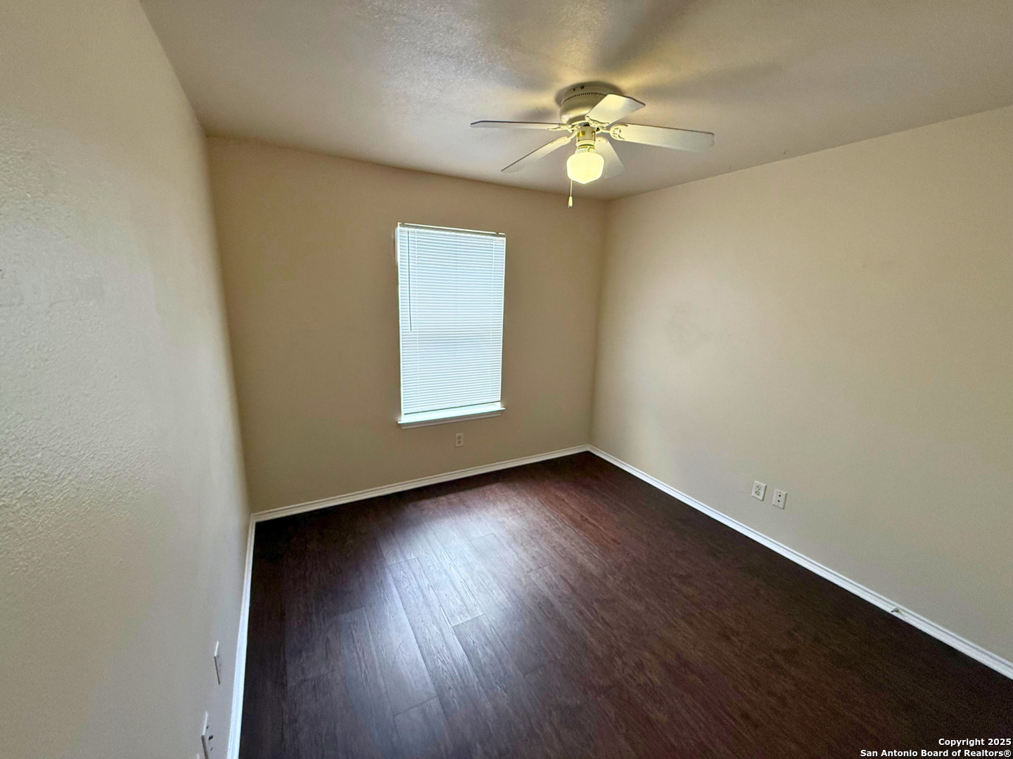 10822 Mathom Landing, Unit 3 Universal City, TX 78148 - Photo 10 of 14 an empty room with wooden floor and windows