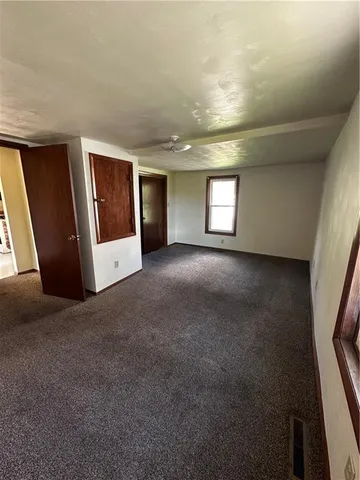 a kitchen with a refrigerator a stove top oven a counter space and wooden floor