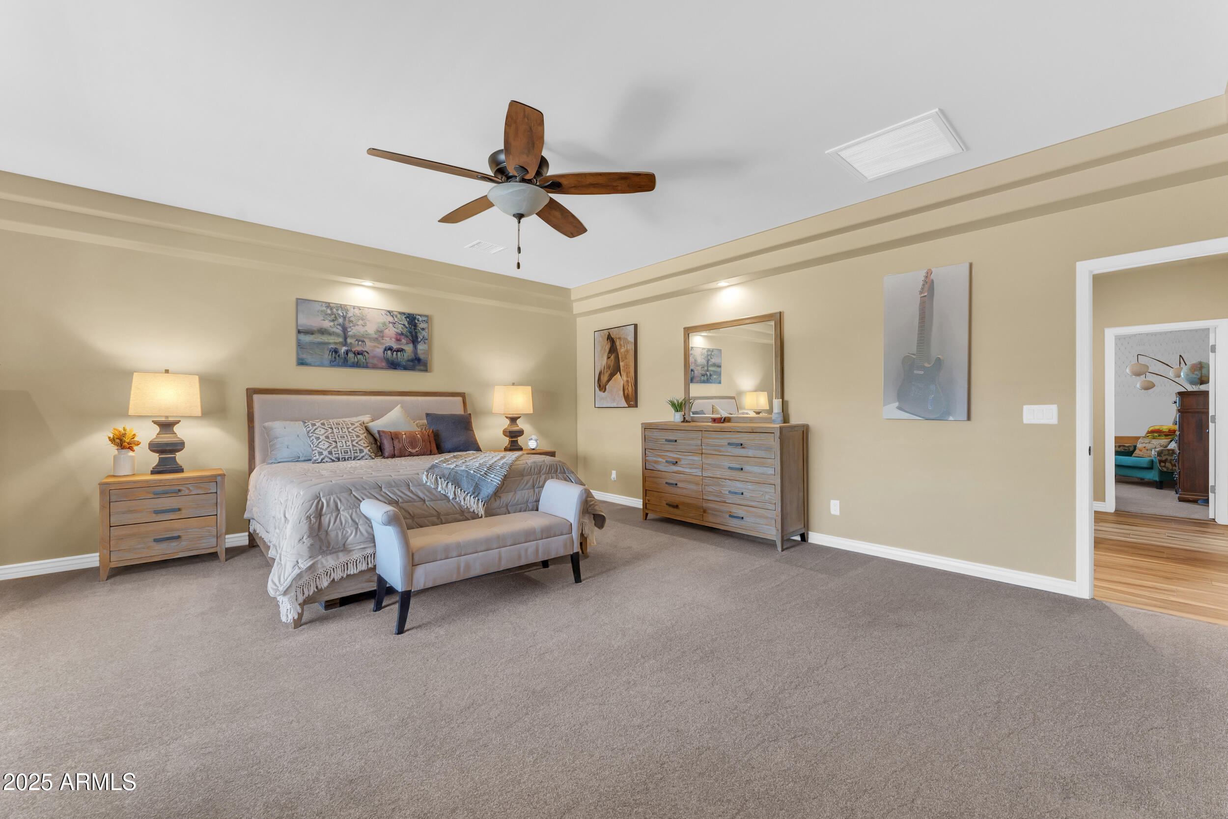 17707 East Stacey Road Queen Creek, AZ 85142 - Photo 33 of 89 a spacious bedroom with a bed and a chandelier