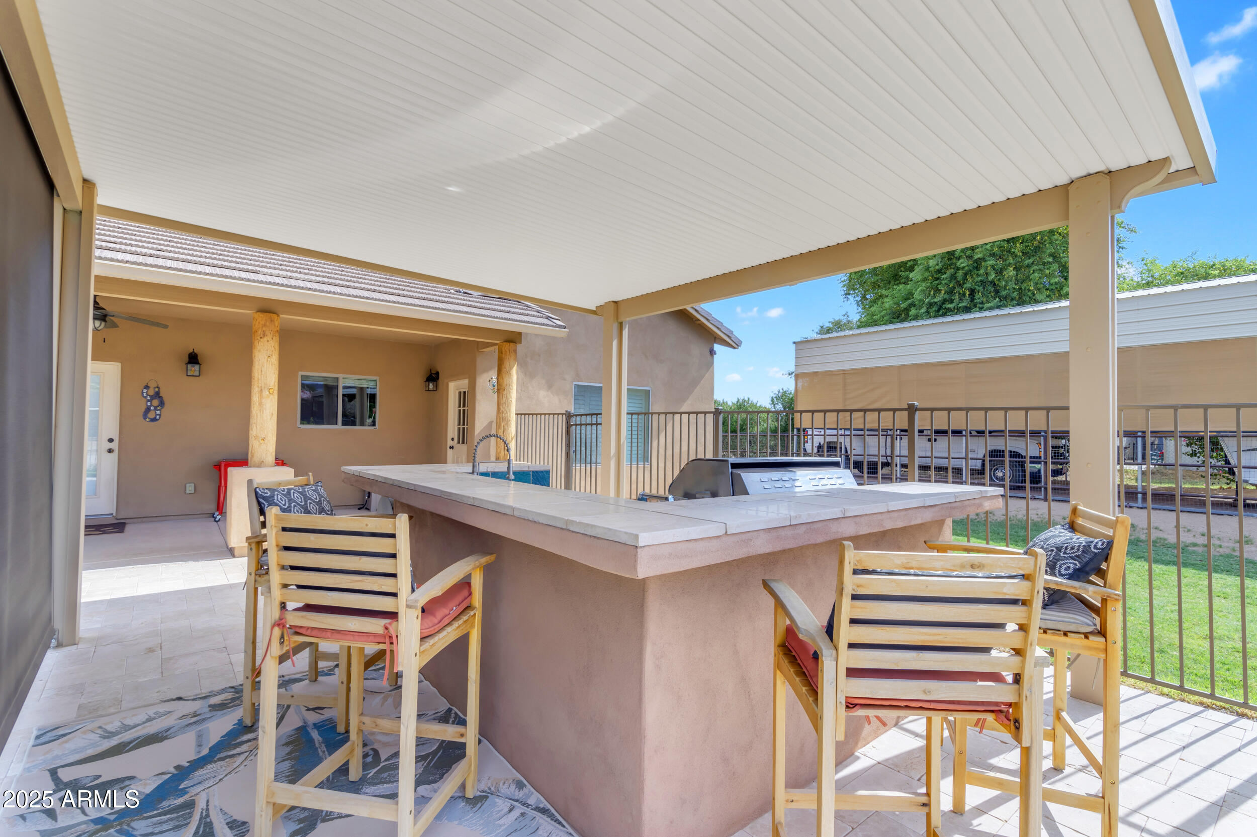 17707 East Stacey Road Queen Creek, AZ 85142 - Photo 55 of 89 a kitchen with a sink a stove and chairs