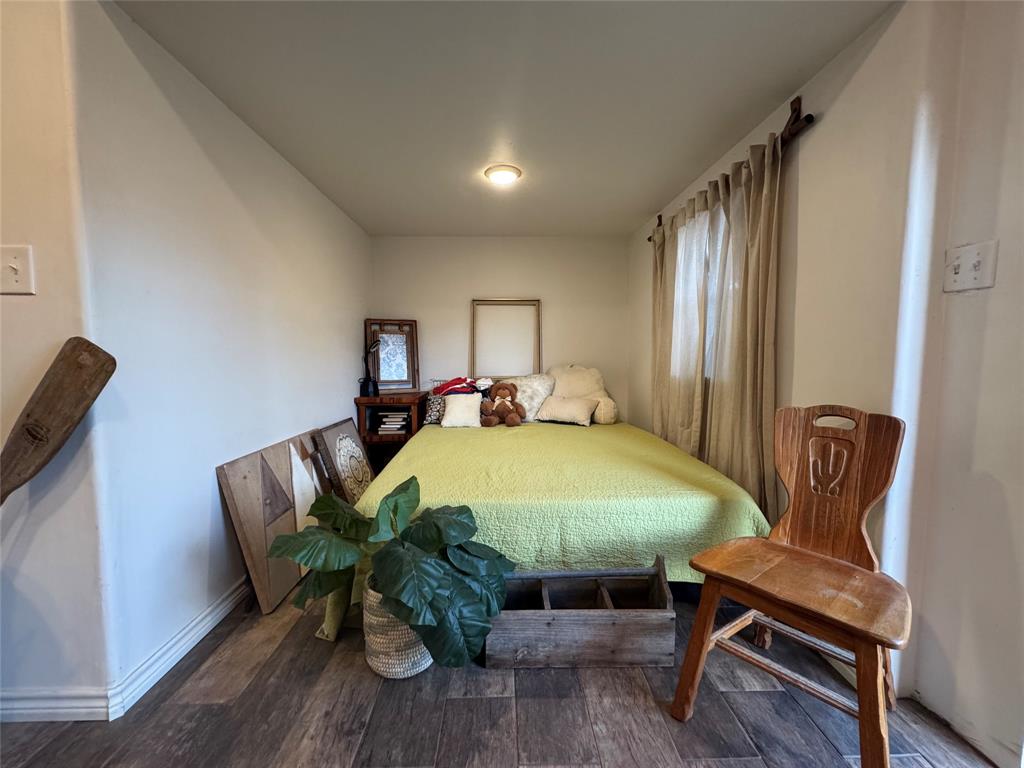 1116 Willow Creek Road Cleburne, TX 76033 - Photo 23 of 25 a bed room with furniture and wooden floor