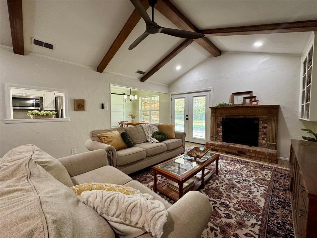 1116 Willow Creek Road Cleburne, TX 76033 - Photo 5 of 25 a living room with furniture a fireplace and a flat screen tv