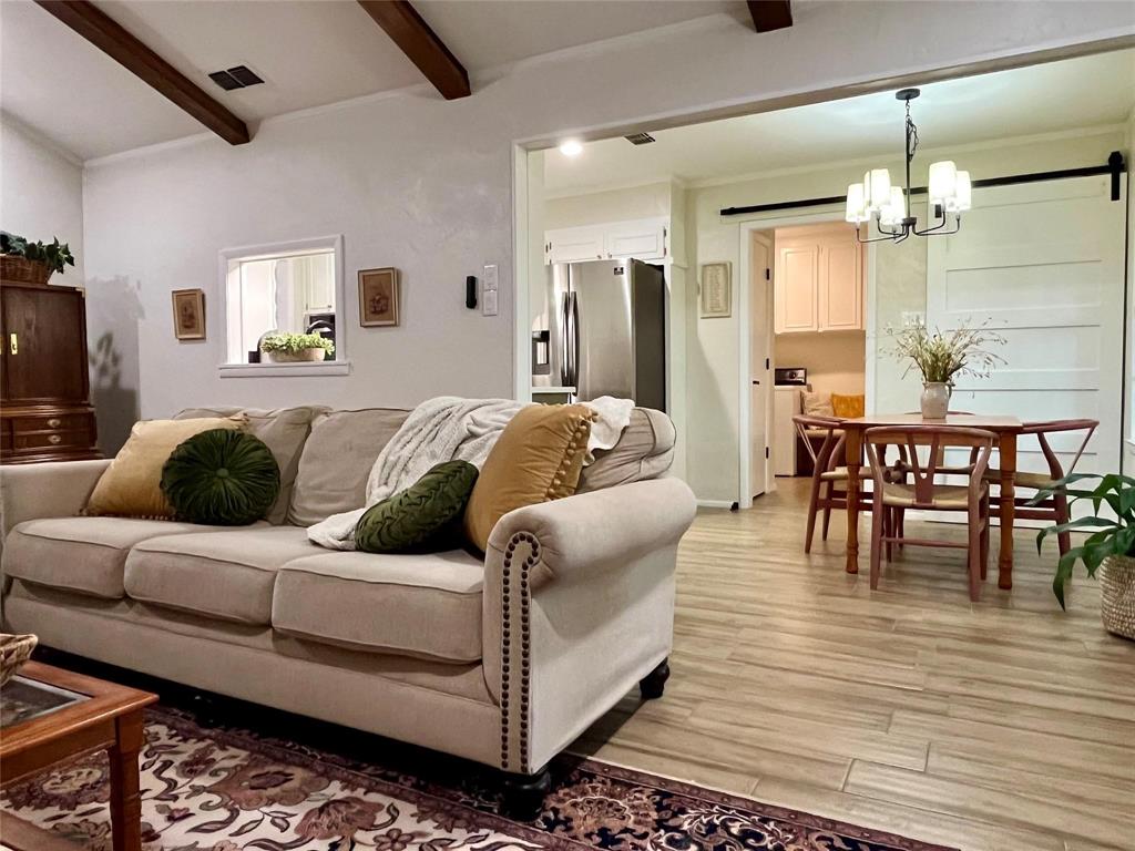 1116 Willow Creek Road Cleburne, TX 76033 - Photo 6 of 25 a living room with furniture a dining table and a chandelier