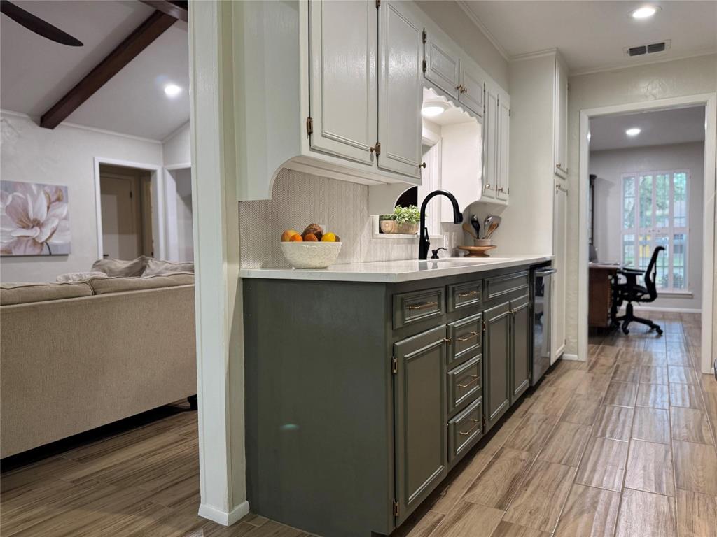1116 Willow Creek Road Cleburne, TX 76033 - Photo 7 of 25 a kitchen with kitchen island granite countertop a sink stainless steel appliances and cabinets