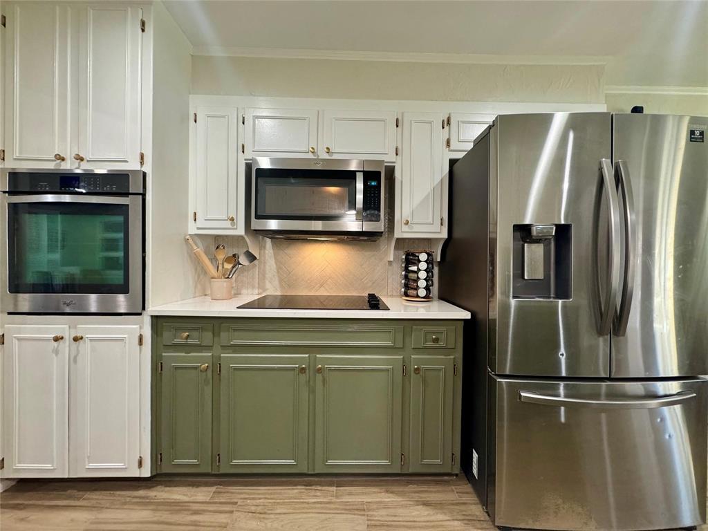 1116 Willow Creek Road Cleburne, TX 76033 - Photo 9 of 25 a kitchen with stainless steel appliances granite countertop a refrigerator and a stove top oven
