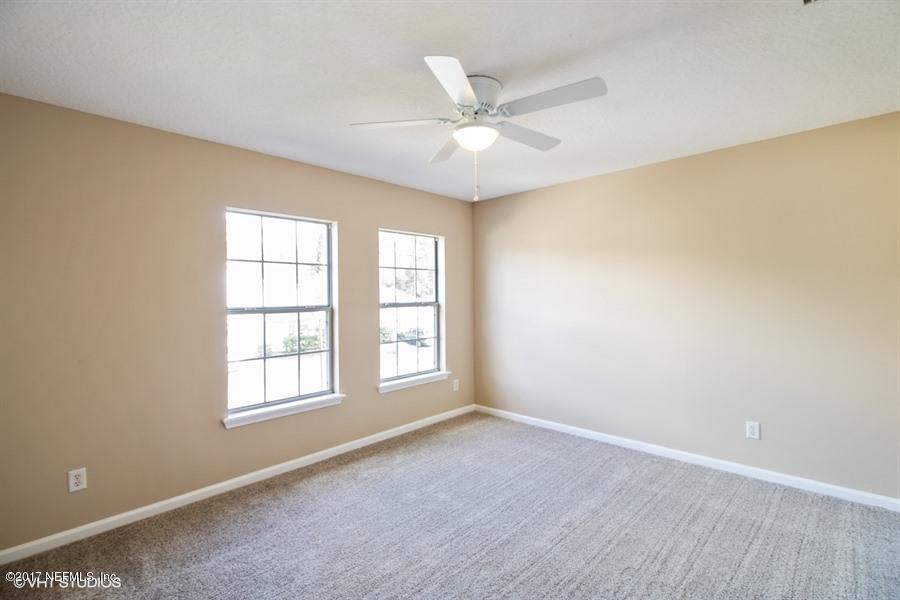 7225 Rampart Ridge Circle West Jacksonville, FL 32244 - Photo 13 of 15 an empty room with windows and fan