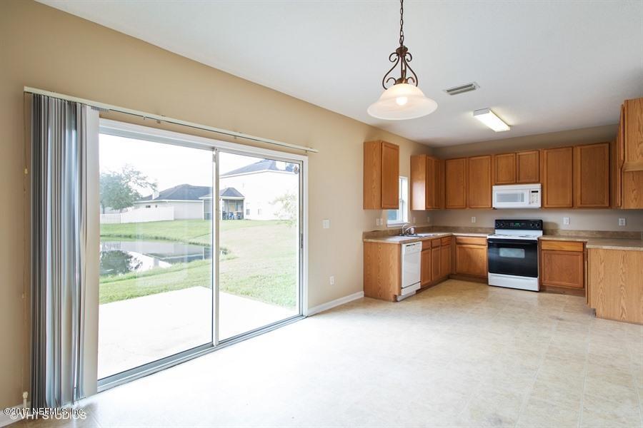 7225 Rampart Ridge Circle West Jacksonville, FL 32244 - Photo 8 of 15 a kitchen with stainless steel appliances a stove top oven and a refrigerator