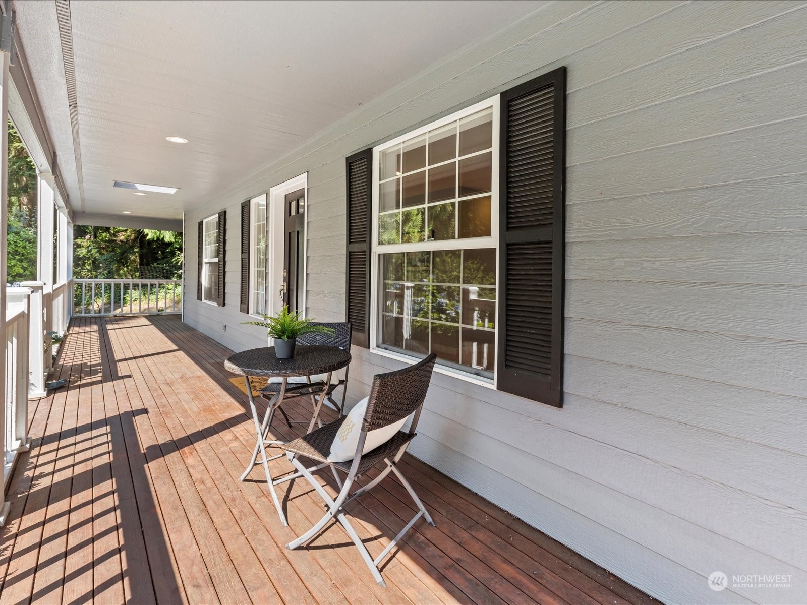 19911 Welch Road Snohomish, WA 98296 - Photo 4 of 40 a view of a patio with table and chairs with wooden floor and fence