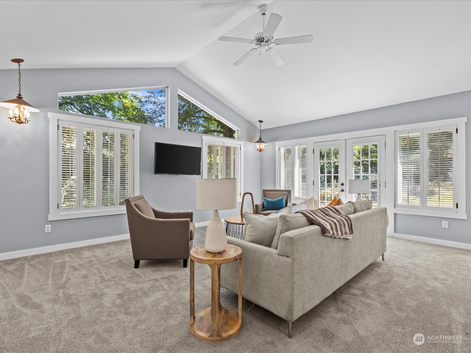 19911 Welch Road Snohomish, WA 98296 - Photo 10 of 40 a living room with furniture a flat screen tv and floor to ceiling windows