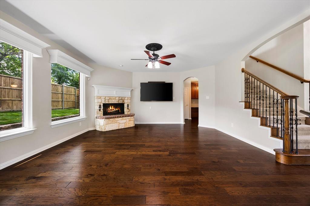 645 Channel Ridge Drive Rockwall, TX 75087 - Photo 14 of 40 The focal point of the warm and inviting family room is the gas log fireplace.