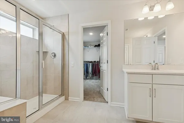 a bathroom with a shower and a sink
