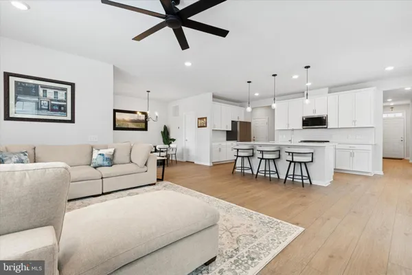 a living room with furniture and kitchen view