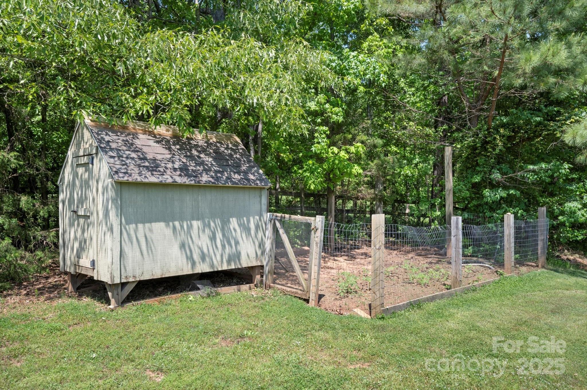 2409 Golf Course Road, Unit 14 Columbus, NC 28722 - Photo 13 of 25 a view of backyard with a barn and large trees