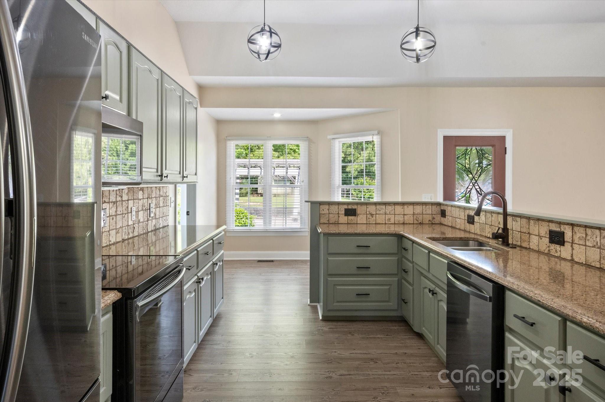 2409 Golf Course Road, Unit 14 Columbus, NC 28722 - Photo 16 of 25 a kitchen with counter top space and stainless steel appliances