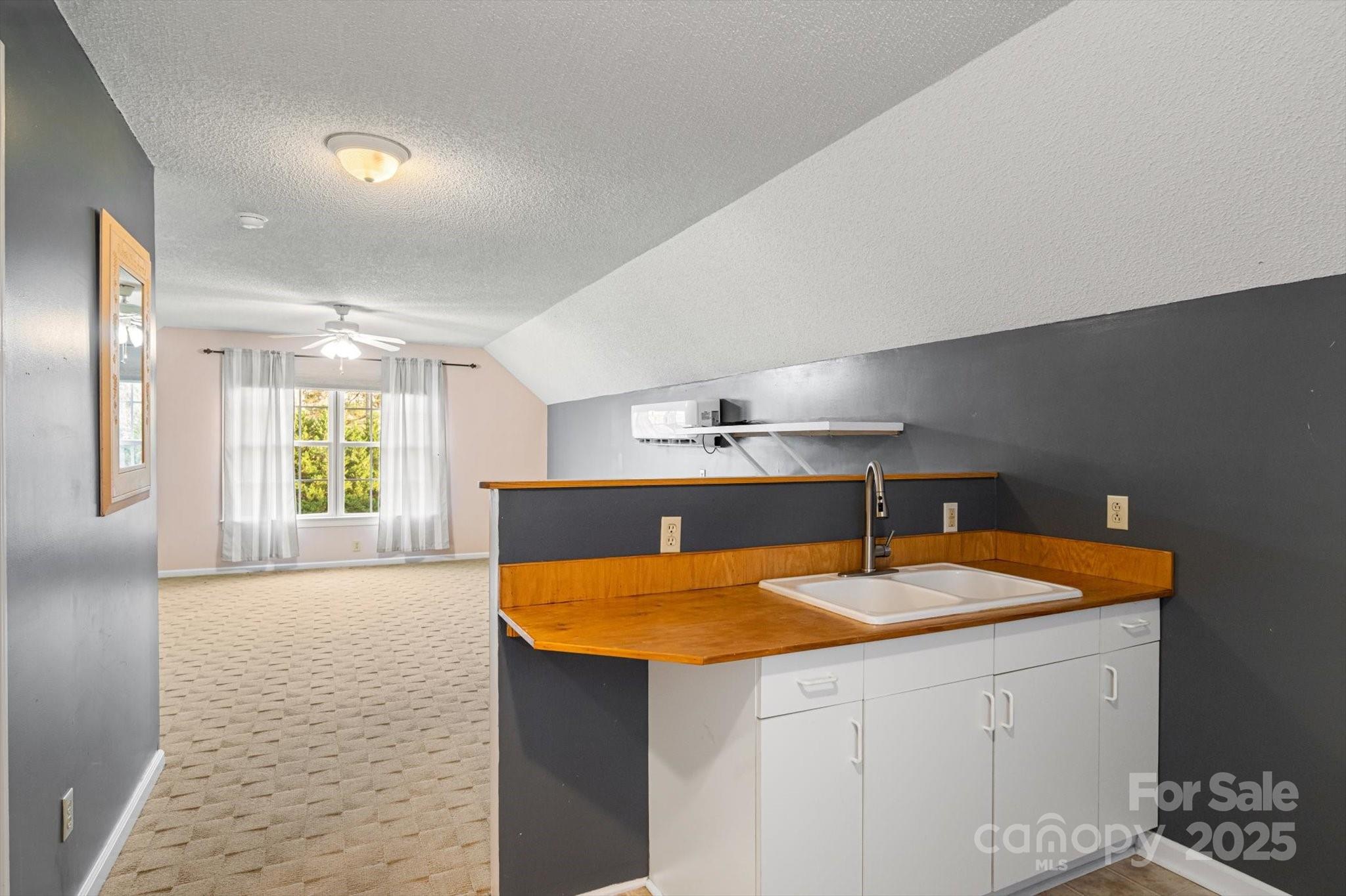 2409 Golf Course Road, Unit 14 Columbus, NC 28722 - Photo 23 of 25 a kitchen that has a sink and a table in it