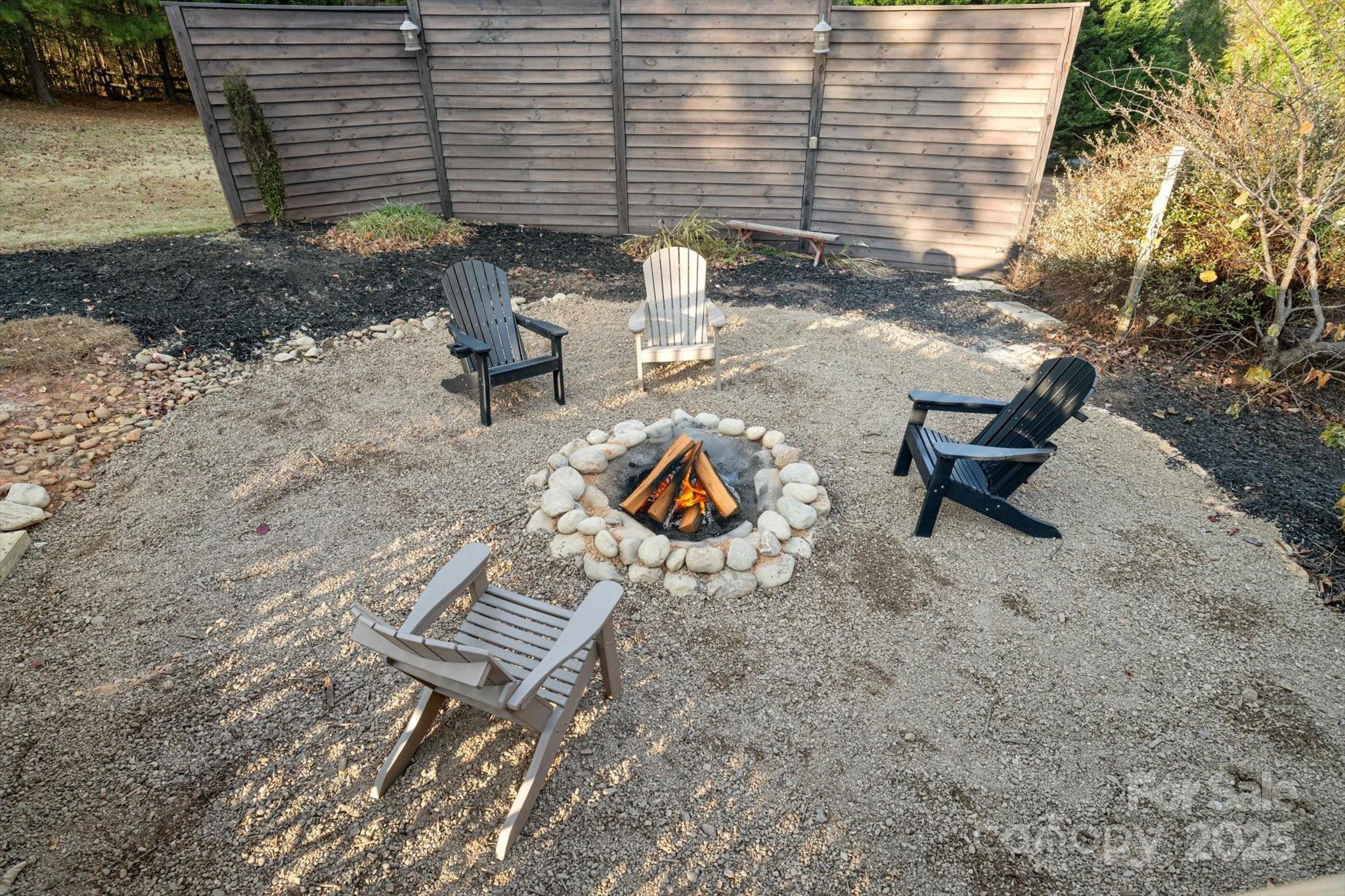 2409 Golf Course Road, Unit 14 Columbus, NC 28722 - Photo 8 of 25 a backyard view of a house with outdoor seating