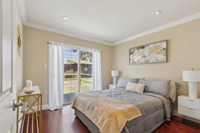 a bedroom with a bed and a large window