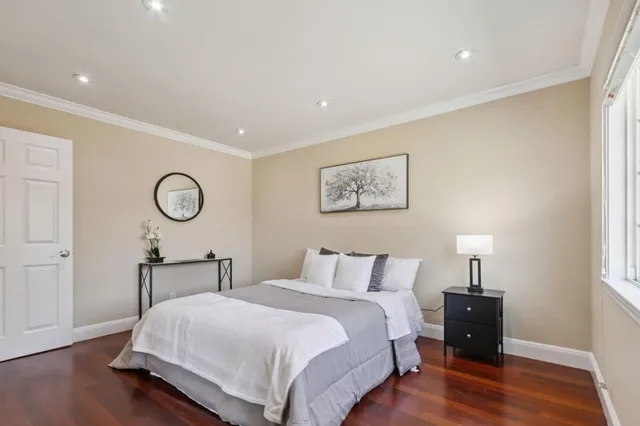 a bedroom with bed and a table