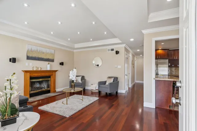 a living room with furniture fireplace and wooden floor