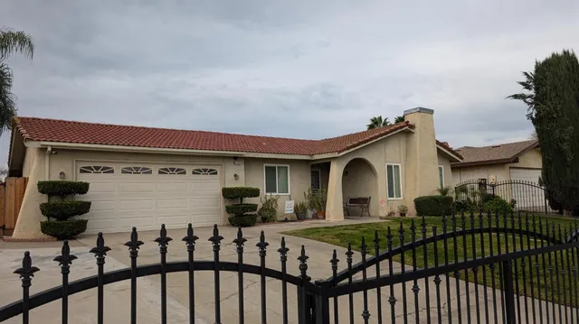 a view of a brick house with large windows