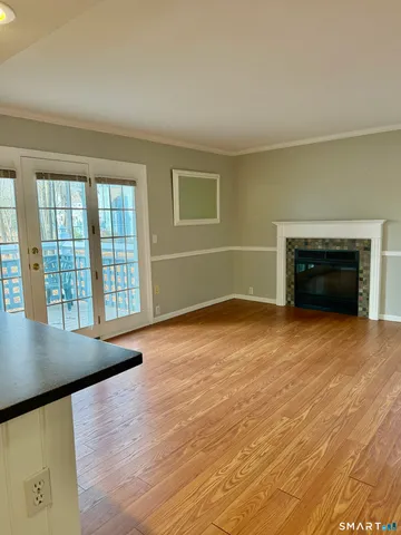 an empty room with windows and fireplace