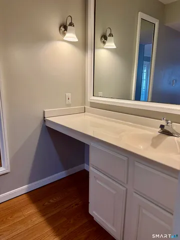 a bathroom with a shower sink and mirror