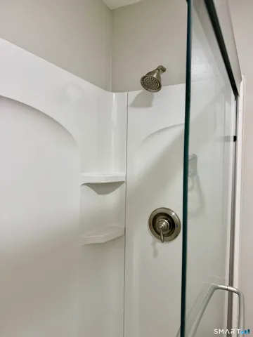 a bathroom with a toilet and a shower