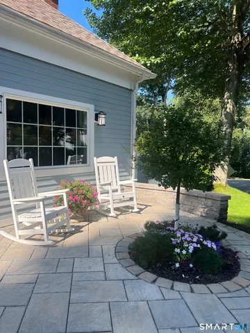 a living room with furniture white walls and a fireplace