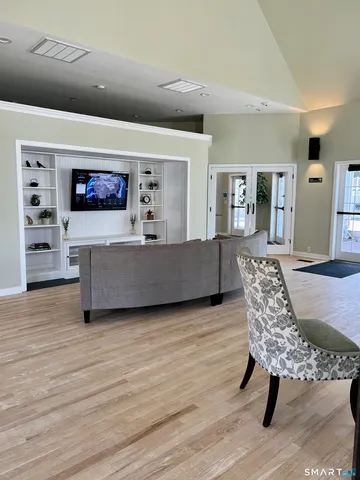 a view of a house with pool and chairs
