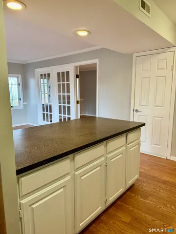 a kitchen with granite countertop a sink a stove and cabinets