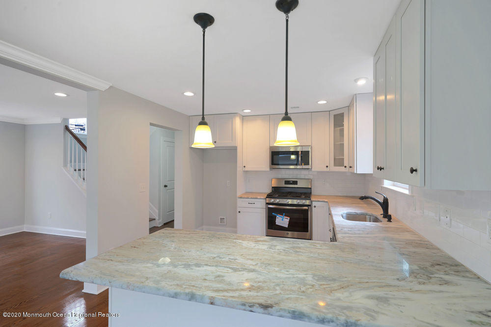 154 Pinehurst Road Brick, NJ 08723 - Photo 14 of 36 a large kitchen with kitchen island a counter space a sink appliances and cabinets