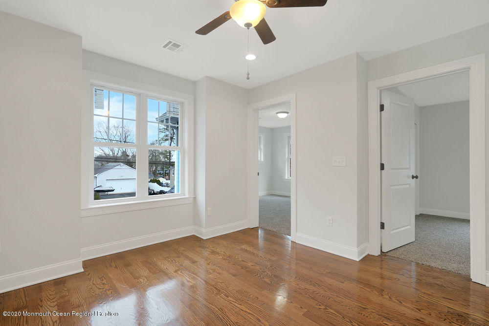154 Pinehurst Road Brick, NJ 08723 - Photo 23 of 36 a view of an empty room with a window and wooden floor