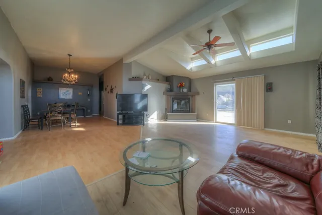 a view of a livingroom with furniture and chandelier fan