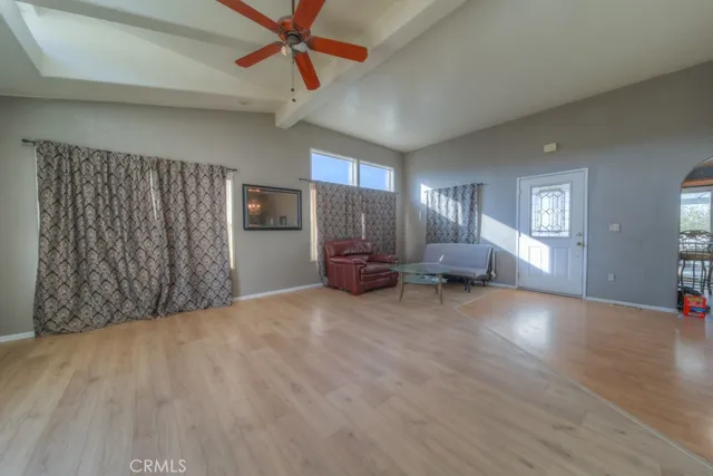 a kitchen with stainless steel appliances granite countertop a sink a stove and a dining table with wooden floor