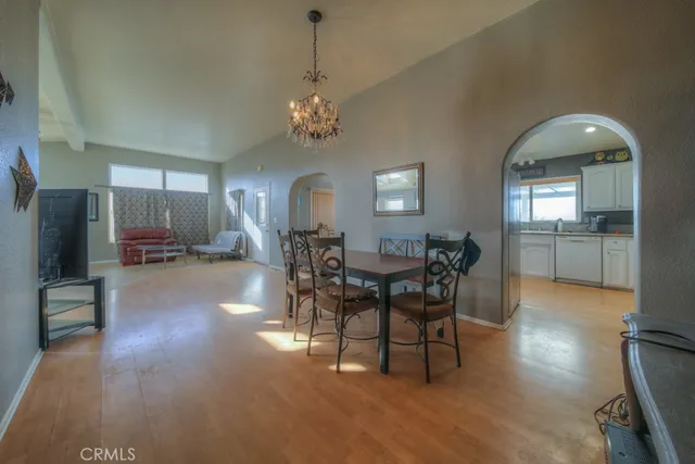 a kitchen with stainless steel appliances granite countertop a sink refrigerator and cabinets