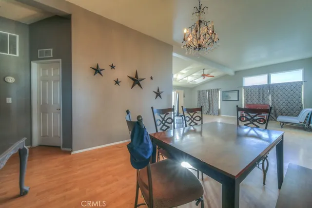 a kitchen with granite countertop white cabinets white appliances a sink and a window