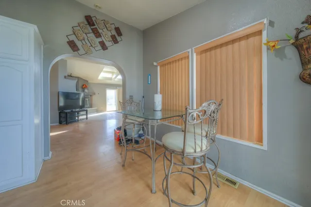 a kitchen with granite countertop a sink window and cabinets