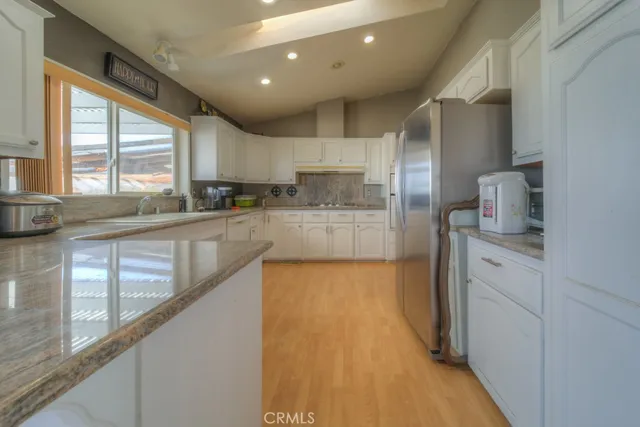 a view of a livingroom with wooden floor and a window