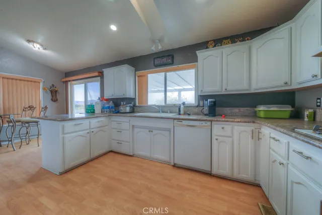 a spacious bedroom with a bed and wooden floor