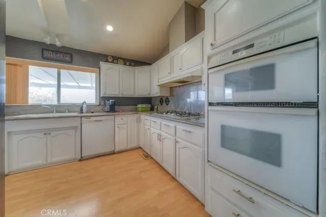 a spacious bedroom with a bed and a chandelier