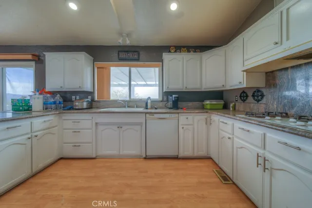 a spacious bedroom with a bed and a window