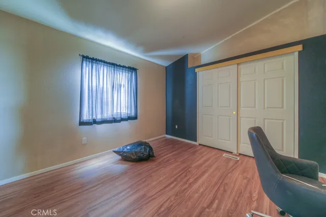 a bedroom with a bed and a mirror