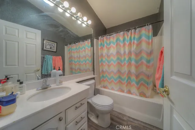 a spacious bathroom with a double vanity sink a mirror and a shower